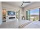 Main bedroom features a linear fireplace, a large television, and city views at 414 Tranquil Peak Ct, Henderson, NV 89012