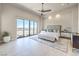 Spacious main bedroom features floor-to-ceiling windows, neutral decor, and a modern ceiling fan at 414 Tranquil Peak Ct, Henderson, NV 89012