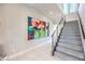 Modern staircase with carpeted steps and stainless steel railings, illuminated by recessed lighting at 414 Tranquil Peak Ct, Henderson, NV 89012