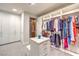 Spacious walk-in closet featuring custom shelving, an island with drawers, and an elevator at 414 Tranquil Peak Ct, Henderson, NV 89012