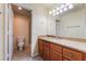 Bathroom with a granite counter top, wood cabinets, toilet and stand up shower at 4400 S Jones Blvd # 2033, Las Vegas, NV 89103
