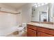 Bathroom featuring a granite counter top, wood cabinets, shower/tub combo and low-flow toilet at 4400 S Jones Blvd # 2033, Las Vegas, NV 89103