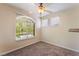 Cozy bedroom with neutral carpet, ceiling fan, and window letting in natural light at 4400 S Jones Blvd # 2033, Las Vegas, NV 89103