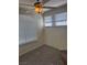 This bedroom features a ceiling fan, neutral walls, grey carpet, and large windows with white blinds at 4400 S Jones Blvd # 2033, Las Vegas, NV 89103