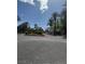 Gated community entrance featuring lush landscaping and towering palm trees under a clear blue sky at 4400 S Jones Blvd # 2033, Las Vegas, NV 89103