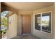 Inviting entryway featuring a paneled front door, window, and covered porch at 4400 S Jones Blvd # 2033, Las Vegas, NV 89103