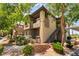 Two-story building exterior with stairs, landscaping, and charming architectural details at 4400 S Jones Blvd # 2033, Las Vegas, NV 89103