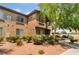 Exterior view of the building with lush landscaping, sidewalks, and covered parking at 4400 S Jones Blvd # 2033, Las Vegas, NV 89103