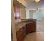 This kitchen features neutral walls, stainless steel dishwasher, wood cabinets and tiled floors at 4400 S Jones Blvd # 2033, Las Vegas, NV 89103