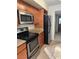 This kitchen features neutral countertops and cabinets, a stainless steel refrigerator and an oven at 4400 S Jones Blvd # 2033, Las Vegas, NV 89103