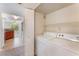 Laundry Room with a full-size washer and dryer next to an open doorway to the kitchen at 4400 S Jones Blvd # 2033, Las Vegas, NV 89103