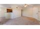 Open-concept living room featuring neutral carpet, breakfast bar, and access to the kitchen at 4400 S Jones Blvd # 2033, Las Vegas, NV 89103