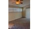 Carpeted living room featuring a ceiling fan and natural lighting at 4400 S Jones Blvd # 2033, Las Vegas, NV 89103