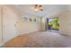 Cozy living room with neutral carpet, ceiling fan, and access to the balcony at 4400 S Jones Blvd # 2033, Las Vegas, NV 89103