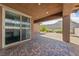 Spacious covered patio with stone pavers and access to a low-maintenance backyard at 485 Pebble Run Ave, Henderson, NV 89011