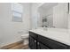 Bathroom with white vanity, mirror, toilet, and shower with patterned curtain at 485 Pebble Run Ave, Henderson, NV 89011