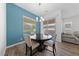 Stylish dining area with hardwood floors, modern lighting, and a view of the backyard at 485 Pebble Run Ave, Henderson, NV 89011