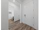 Bright entryway showcasing hardwood floors, a white front door, and an open view of the bathroom at 485 Pebble Run Ave, Henderson, NV 89011