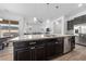 Beautiful kitchen island with granite countertop and stainless steel appliances overlooking living room at 485 Pebble Run Ave, Henderson, NV 89011