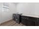 Well-equipped laundry room featuring modern washer/dryer units and ample counter space at 485 Pebble Run Ave, Henderson, NV 89011