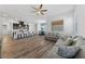 Open-concept living space featuring hardwood floors and seamless transitions to the kitchen and dining area at 485 Pebble Run Ave, Henderson, NV 89011