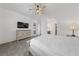 Bright main bedroom featuring a bed, dresser, fan, and access to the bathroom at 485 Pebble Run Ave, Henderson, NV 89011