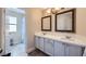 Bathroom with double vanity, modern lighting, framed mirrors and separate room for the shower at 5502 Cinnamon Ave, Las Vegas, NV 89122