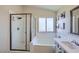 Inviting bathroom featuring a separate shower, tub, and single vanity at 5502 Cinnamon Ave, Las Vegas, NV 89122
