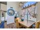 Bright dining area with wood-look floors, a rustic table, and natural light at 5502 Cinnamon Ave, Las Vegas, NV 89122