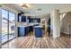 Bright, open kitchen with island, stainless steel appliances, and sliding glass doors to the backyard at 5502 Cinnamon Ave, Las Vegas, NV 89122