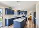 Well-lit kitchen with navy cabinets, white countertops, stainless steel appliances, and island at 5502 Cinnamon Ave, Las Vegas, NV 89122