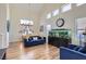 Spacious living room showcasing wood-look floors, high ceilings, and dining area at 5502 Cinnamon Ave, Las Vegas, NV 89122