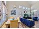 Inviting living space with wood-look floors, vaulted ceilings, dining table, and comfortable sofa at 5502 Cinnamon Ave, Las Vegas, NV 89122