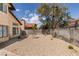 Large backyard with rock landscaping and a tall privacy fence, offering a blank canvas for outdoor enjoyment at 6436 Deadwood Rd, Las Vegas, NV 89108