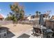 Spacious backyard perfect for entertaining, featuring a patio set, rock landscape and surrounding block wall at 6436 Deadwood Rd, Las Vegas, NV 89108