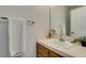 Cozy bathroom featuring a vanity with a white sink and neutral-colored countertop with a framed mirror at 6436 Deadwood Rd, Las Vegas, NV 89108