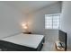 Well-lit bedroom featuring a comfortable mattress, side table with a lamp, and a television screen for relaxation at 6436 Deadwood Rd, Las Vegas, NV 89108