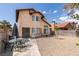 Charming two-story home with stucco exterior, red tile roof, rock landscaping and a spacious patio set at 6436 Deadwood Rd, Las Vegas, NV 89108