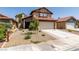 Charming two-story home with a red tile roof and a well-maintained front yard in a residential neighborhood at 6436 Deadwood Rd, Las Vegas, NV 89108