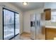 Kitchen area featuring a stainless steel refrigerator and a sliding door leading to an outdoor patio at 6436 Deadwood Rd, Las Vegas, NV 89108