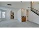 Spacious living room featuring a wet bar and a staircase, adjacent to an opening into the kitchen at 6436 Deadwood Rd, Las Vegas, NV 89108