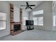 Bright living room featuring high ceilings, a brick fireplace, and large windows with blinds at 6436 Deadwood Rd, Las Vegas, NV 89108