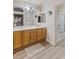 Well-lit bathroom with double vanity, framed mirrors, and a shower at 6525 Raven Hall St, North Las Vegas, NV 89084