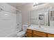 Bright bathroom boasts a shower-tub combo and a wood-finished vanity at 6525 Raven Hall St, North Las Vegas, NV 89084