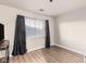 Bedroom features a large window and luxury vinyl plank flooring at 6525 Raven Hall St, North Las Vegas, NV 89084