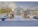 Inviting two-story home featuring a well-kept front yard, neutral tones, and an attached two-car garage at 6525 Raven Hall St, North Las Vegas, NV 89084