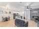 Open-concept living room and kitchen featuring stainless steel appliances, granite counters and a cozy fireplace at 6525 Raven Hall St, North Las Vegas, NV 89084