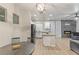 Bright living room with an electric fireplace, ceiling fan and kitchen at 6525 Raven Hall St, North Las Vegas, NV 89084