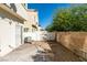 Backyard featuring a brick patio, gravel, a brick wall, and a white fence at 6549 Clara Bow Ave # 103, Las Vegas, NV 89122