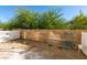 Backyard featuring a brick wall, gravel, a ladder, and a white fence at 6549 Clara Bow Ave # 103, Las Vegas, NV 89122